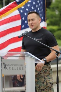Marine Corps recruiter speaks at the podium