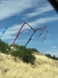Extended Pump Trucks flying American Flags on hillside