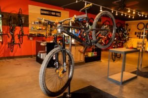 Interior view of bike shop with bike on rack in foreground