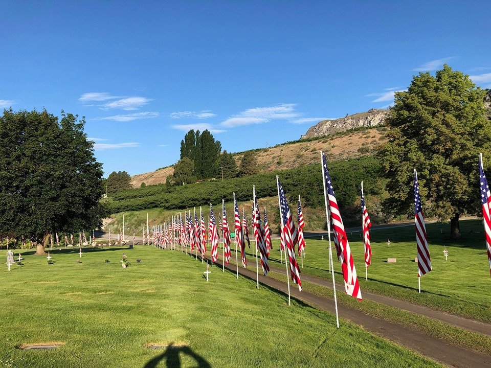 flags lining the driveway at the Brewster cemetery