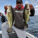 Tony Warren holding up 2 fish he caught