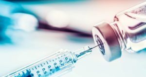 Close-up medical syringe with a vaccine